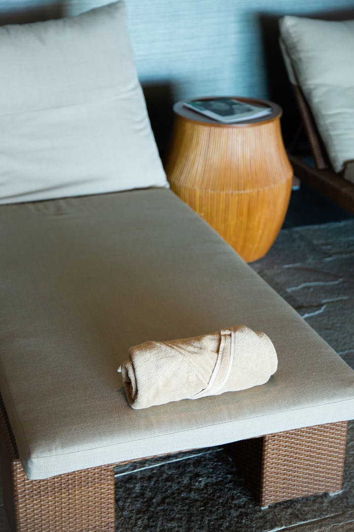 About Elegant spa setting with a brown towel on a rattan lounger, perfect for relaxation visuals.