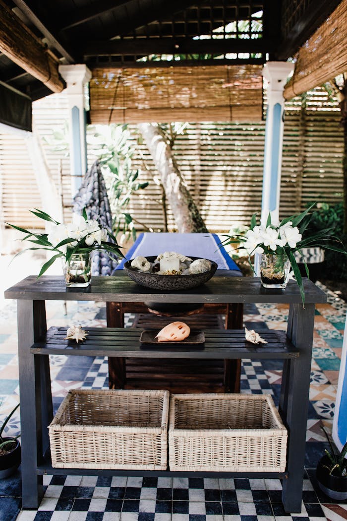 Elegant outdoor spa setting with a massage table and decorative elements in a serene atmosphere.