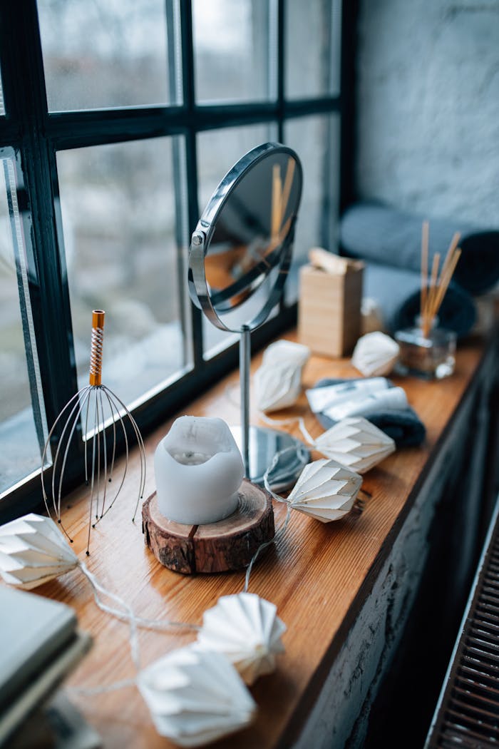 A serene arrangement of home spa items by a window, creating a peaceful atmosphere.
